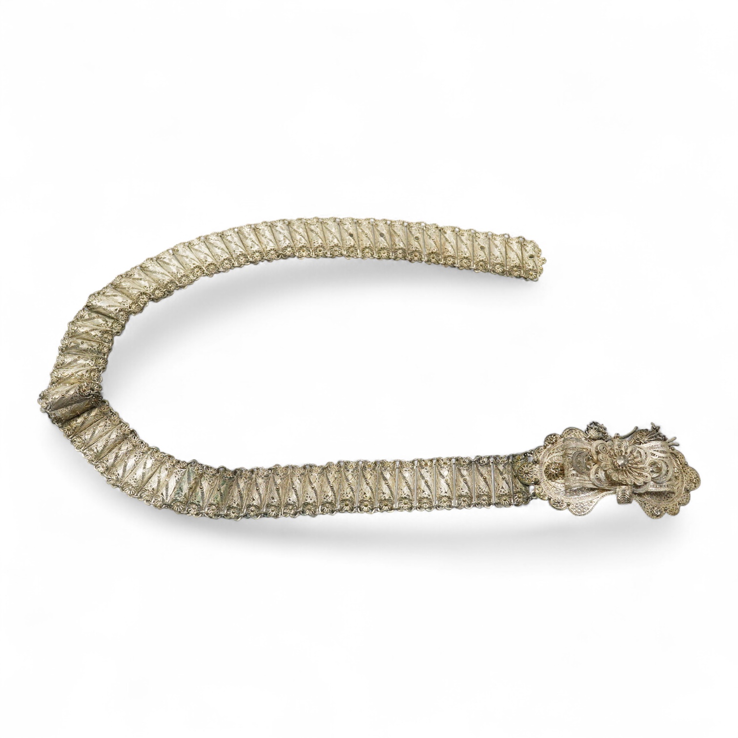 An Indian white metal filigree belt, 86cm.